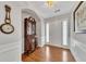 Elegant foyer featuring hardwood floors, a charming secretary, and a well-lit entryway at 6690 Cold Stream Dr, Cumming, GA 30040