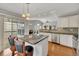 Kitchen with granite island bar, stainless steel appliances and an adjacent dining area at 6690 Cold Stream Dr, Cumming, GA 30040