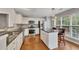 Bright kitchen boasts granite countertops, stainless steel appliances, and hardwood floors at 6690 Cold Stream Dr, Cumming, GA 30040