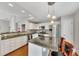 Modern kitchen with an island, granite counters, stainless appliances, and hardwood floors at 6690 Cold Stream Dr, Cumming, GA 30040