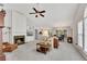 Spacious living room with a cozy fireplace, built-in shelving, and an open layout to the dining area at 6690 Cold Stream Dr, Cumming, GA 30040