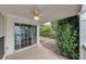 Covered patio with ceiling fan and sliding glass doors leading to backyard with lush greenery at 6690 Cold Stream Dr, Cumming, GA 30040