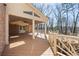Back porch with a ceiling fan, wood decking and a railing with wooded views at 7690 Classic Way, Atlanta, GA 30350