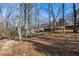 Large backyard with seating area nestled among mature trees at 7690 Classic Way, Atlanta, GA 30350