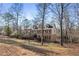 Stately brick home with a sprawling backyard and mature trees, perfect for outdoor enjoyment at 7690 Classic Way, Atlanta, GA 30350