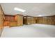 Finished basement features a built-in bar, wood paneled walls and a light colored floor at 7690 Classic Way, Atlanta, GA 30350