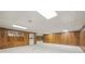 Basement features wood paneled walls, white floor and ceiling tiles, and a walkout door at 7690 Classic Way, Atlanta, GA 30350