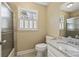 Well-lit bathroom with tiled walk-in shower, toilet, and single sink vanity at 7690 Classic Way, Atlanta, GA 30350
