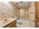 Bathroom with a patterned wallpaper, shower and tub, single sink and toilet at 7690 Classic Way, Atlanta, GA 30350
