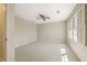Spacious bedroom featuring a ceiling fan, carpeted floor, and window with natural light at 7690 Classic Way, Atlanta, GA 30350