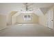 Bedroom featuring a carpeted floor, ceiling fan, a bright window and angled ceilings at 7690 Classic Way, Atlanta, GA 30350