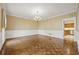 Formal dining room featuring elegant wainscoting, classic chandelier, and wood floors at 7690 Classic Way, Atlanta, GA 30350