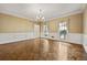 Bright dining room with hardwood floors, decorative windows and wainscoting details at 7690 Classic Way, Atlanta, GA 30350