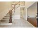 Inviting foyer with tile flooring, grand staircase, and elegant wainscoting at 7690 Classic Way, Atlanta, GA 30350