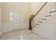 Spacious foyer features tile flooring, staircase, and ample natural light from front door at 7690 Classic Way, Atlanta, GA 30350