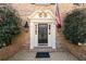 Charming brick home featuring a stylish front door with sidelights and decorative trim at 7690 Classic Way, Atlanta, GA 30350