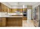 Bright kitchen featuring stainless appliances, granite countertops, and island with storage at 7690 Classic Way, Atlanta, GA 30350