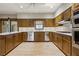 Traditional kitchen with stainless steel appliances, granite countertops, and wooden cabinets at 7690 Classic Way, Atlanta, GA 30350