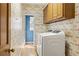 Bright laundry room with colorful wallpaper and new washer and dryer at 7690 Classic Way, Atlanta, GA 30350