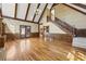 Open living room with fireplace, built-in shelves, wood floors, and staircase at 7690 Classic Way, Atlanta, GA 30350