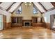 Cozy living room featuring a fireplace, built-in shelves and hardwood floors at 7690 Classic Way, Atlanta, GA 30350