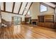 Bright living room features a fireplace, built-in shelves, hardwood floors, and vaulted ceilings at 7690 Classic Way, Atlanta, GA 30350