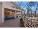 Covered porch provides outdoor retreat with wooded backyard at 7690 Classic Way, Atlanta, GA 30350