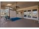 Covered porch featuring brick wall, ceiling fan and blue accent rug at 7690 Classic Way, Atlanta, GA 30350