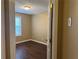 Bedroom featuring neutral walls, wood flooring, and a bright window at 875 Under Ct, Sugar Hill, GA 30518