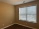 Bedroom featuring neutral walls, wood flooring, and a bright window at 875 Under Ct, Sugar Hill, GA 30518