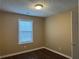 Bedroom featuring neutral walls, wood flooring, and a bright window at 875 Under Ct, Sugar Hill, GA 30518