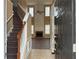 Inviting entryway with high ceilings, decorative staircase, and views of the living area with a fireplace at 875 Under Ct, Sugar Hill, GA 30518