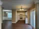 Open kitchen features white cabinetry, appliances, and a view into the adjacent dining area at 875 Under Ct, Sugar Hill, GA 30518