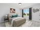 Cozy bedroom featuring a comfortable bed, soft carpet, and a large window with a view of green lawn at 708 Ocmulgee Xing, Locust Grove, GA 30248