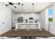 Bright kitchen features white cabinets, stainless steel appliances, an island with seating and modern pendant lighting at 708 Ocmulgee Xing, Locust Grove, GA 30248