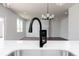 Modern faucet on bright kitchen island with stainless steel sink, white countertops, and pendant lighting at 708 Ocmulgee Xing, Locust Grove, GA 30248