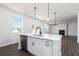 Bright kitchen island with stainless steel dishwasher, white countertops, modern faucet, and pendant lighting at 708 Ocmulgee Xing, Locust Grove, GA 30248