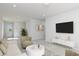 Upstairs living room with plush neutral seating, tv, modern decor and bright sunny windows at 708 Ocmulgee Xing, Locust Grove, GA 30248