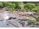 Picturesque river view featuring rock formations, vegetation and clear waters at 708 Ocmulgee Xing, Locust Grove, GA 30248