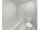 This refreshed bathroom features a white tiled shower over tub and a low-flow toilet at 8072 Crystal Ln, Douglasville, GA 30134