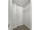 Walk-in closet with neutral paint and carpet and a wire rack ready for storage at 8072 Crystal Ln, Douglasville, GA 30134