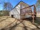 A charming exterior view featuring a quaint deck entrance and light-colored horizontal siding at 8072 Crystal Ln, Douglasville, GA 30134
