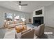 Bright living room featuring a fireplace, large windows, and neutral-colored furniture at 8072 Crystal Ln, Douglasville, GA 30134