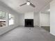 Open living room with a fireplace, neutral carpeting and bright natural light at 8072 Crystal Ln, Douglasville, GA 30134