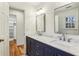 Bright bathroom featuring a double vanity with marble countertop, undermount sinks, and updated fixtures at 1334 Wyntercreek Ln, Dunwoody, GA 30338