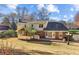 Back exterior of home featuring large yard, deck, and screened in porch at 1334 Wyntercreek Ln, Dunwoody, GA 30338