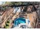 Aerial view of the backyard featuring a pool, spa, patio, outdoor seating, and basketball court at 14 Long Island Pl., Atlanta, GA 30328