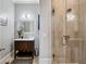Bathroom with a modern vanity, framed mirror, and glass-enclosed shower with stylish tile at 14 Long Island Pl., Atlanta, GA 30328