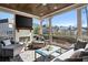 Elegant covered porch with cozy seating and an outdoor fireplace at 14 Long Island Pl., Atlanta, GA 30328
