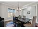 Stylish dining room featuring a modern chandelier, natural light, and elegant furniture, ideal for Gathering meals at 14 Long Island Pl., Atlanta, GA 30328